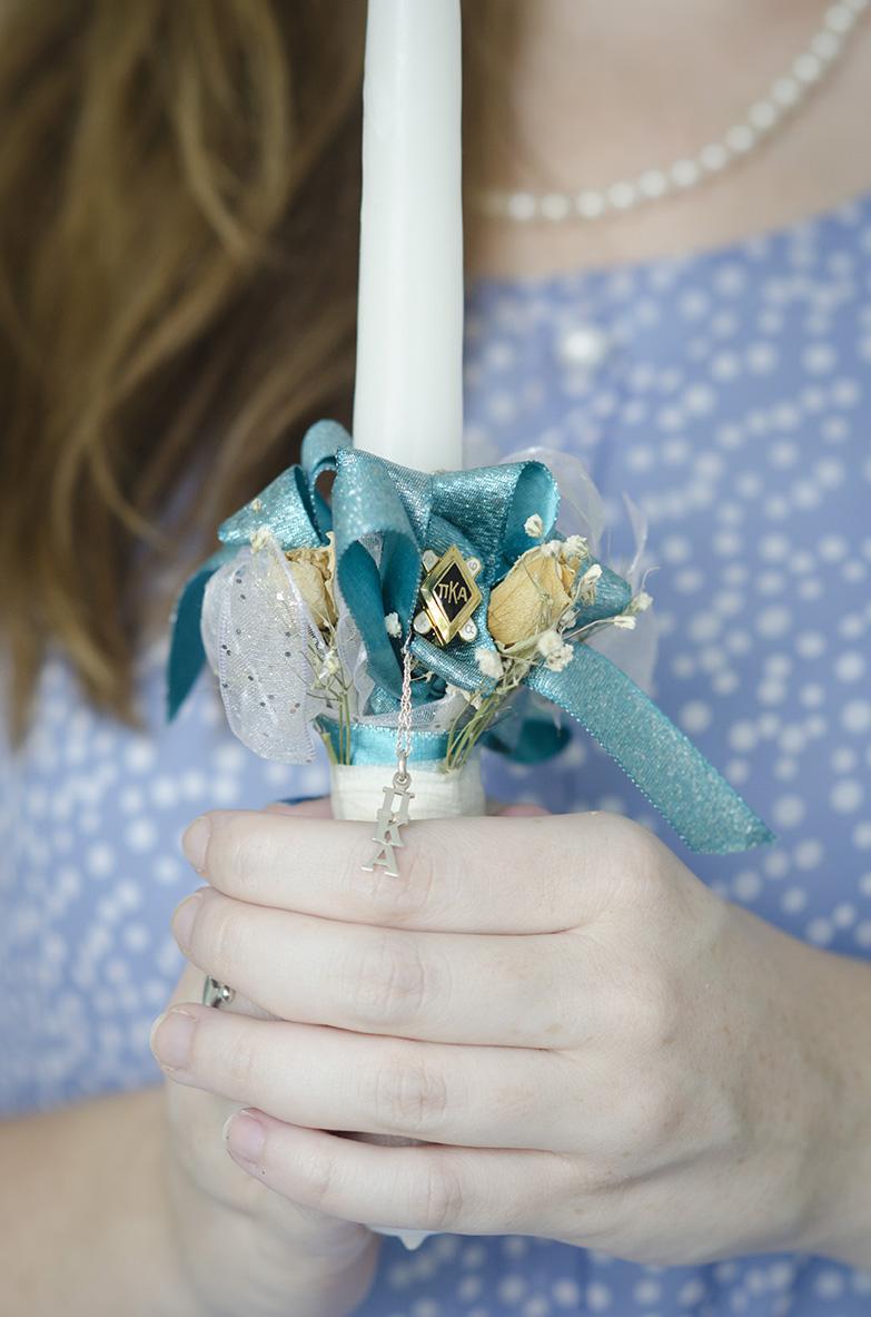 Danielle Kelley, Zeta Tau Alpha alumna, holds the candle that was presented to her by her boyfriend's fraternity during the lavaliering ceremony.