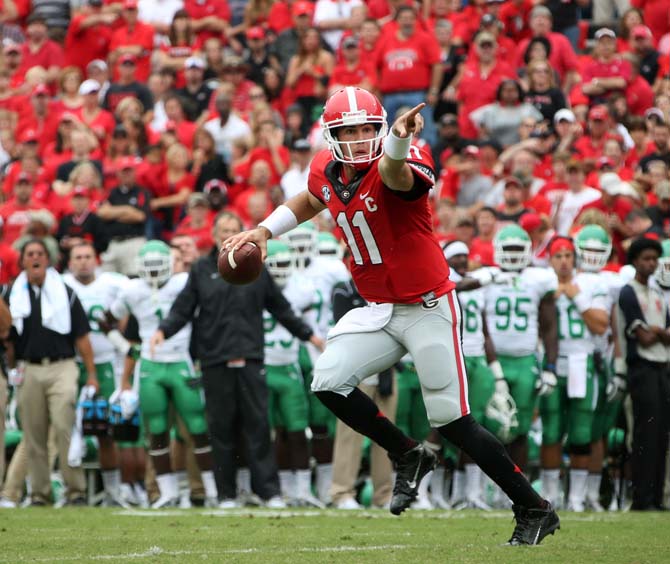 Georgia quarterback Aaron Murray (11) rolls out of the pocket before he throws an interception in the end zone in the first half of an NCAA college football game against North Texas at Sanford Stadium Saturday, Sept. 21, 2013, in Athens, Ga. (AP Photo/Atlanta Journal-Constitution, Jason Getz ) MARIETTA DAILY OUT; GWINNETT DAILY POST OUT; LOCAL TV OUT; WXIA-TV OUT; WGCL-TV OUT