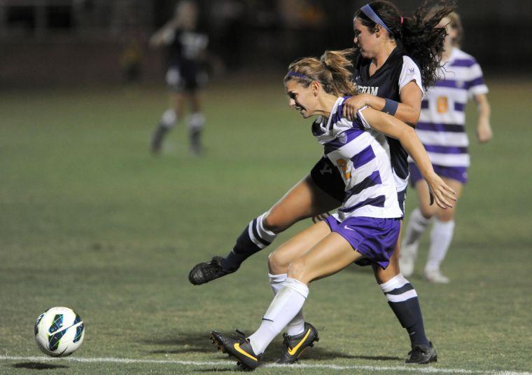 LSU senior defender Addie Eggleston (2) fights a Brigham Young University player off of her back Monday, Sept. 2, 2013, at the LSU Soccer Stadium.