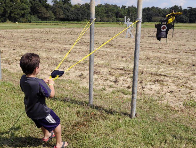 A maze-goer launches water balloons at spooky cutouts Saturday afternoon Sept. 28 2013 at the Corn Maze of the LSU AgCenter Botanic Gardens at Burden.