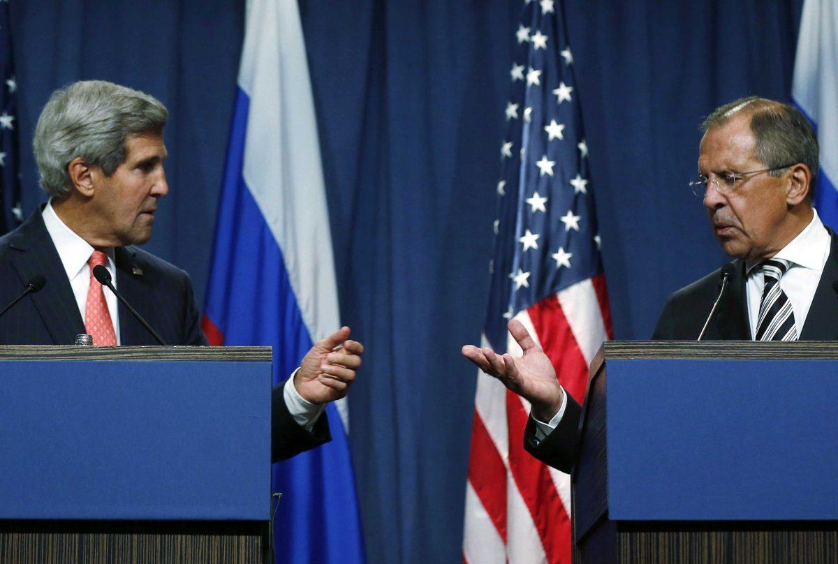 U.S. Secretary of State John Kerry, left, and Russian Foreign Minister Sergei Lavrov, gesture while making statements to the media following meetings regarding Syria, at a news conference in Geneva, Switzerland, Saturday Sept. 14, 2013. U.S. Secretary of State Kerry and Russian Foreign Minister Lavrov said Saturday they have reached an agreement on a framework for Syria to destroy all of its chemical weapons, and would seek a U.N. Security Council resolution that could authorize sanctions, short of military action, if Syrian President Bashar Assad's government fails to comply. (AP Photo / Larry Downing)