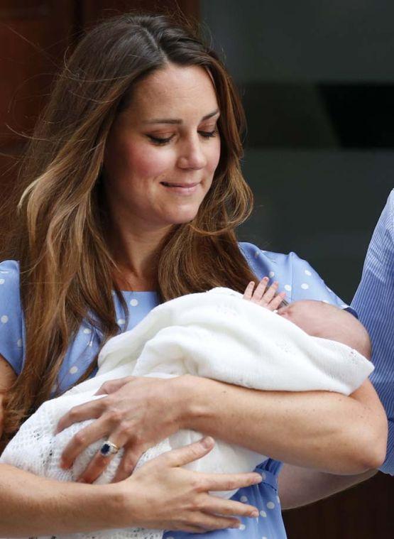 Kate, Duchess of Cambridge looks down as she holds the Prince of Cambridge, Tuesday July 23, 2013, as she poses for photographers outside St. Mary's Hospital exclusive Lindo Wing in London where the Duchess gave birth on Monday July 22. The Royal couple are expected to head to London's Kensington Palace from the hospital with their newly born son, the third in line to the British throne. (AP Photo/Lefteris Pitarakis)