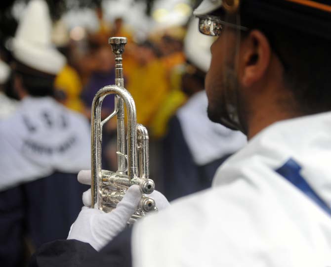 Rain falls on a trumpet player Saturday, September 21, 2013, during the pre-game festivities before the LSU vs. Auburn game in Tiger Stadium.