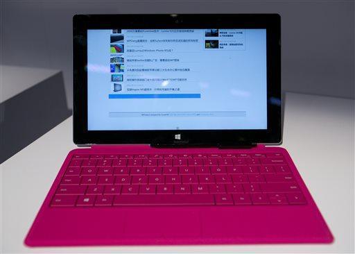 A new Surface tablet computer, with a pink Type Cover 2, are introduced, Monday, Sept. 23, 2013 in New York. The redesigned Surface tablets come at a time of transition for Microsoft. (AP Photo/Mark Lennihan)