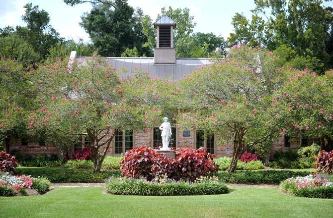 A statue stands tall over a garden Sept. 18, 2013, at the Burden Museum and Gardens.