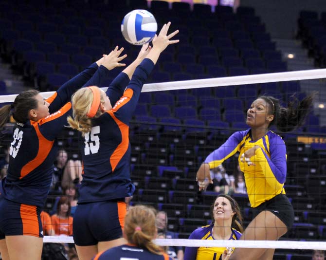 Junior, Malorie Pardo (14), watches as Sophomore, Khourtni Fears (1) spikes in for kill Friday Aug. 30, 2013 against Texas San Antonio