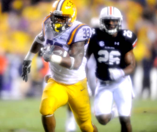 LSU sophomore running back Jeremy Hill (33) attempts to evade a defender Saturday, Sept. 21, 2013 during the Tigers' matchup against Auburn in Tiger Stadium.