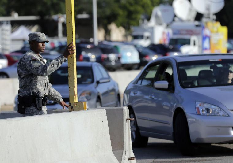 FILE - In this Aug. 28, 2013 file photo, a soldier raises the gate at a security point to enter the Lawrence William Judicial Center as the sentencing phase for Maj. Nidal Hasan continues in Fort Hood, Texas. Hasan was convicted of killing 13 of his unarmed comrades in the deadliest attack ever on a U.S. military base. The rampage Monday, Sept. 16, 2013, at the Washington Naval Yard shocked the military, just as the attack at Fort Hood did. Defense Secretary is ordering a review of base security worldwide and the issuing of security clearances that allow access to them, vowing: "Where there are gaps, we will close them." (AP Photo/Eric Gay, File)