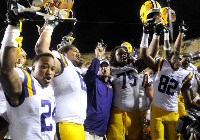 LSU head coach Les Miles sings the alma mater with his team Saturday, Sept. 21, 2013 after the Tigers' 35-21 victory against Auburn in Tiger Stadium.