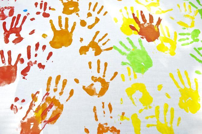 Rainbow colored handprints cover a banner at Spectrum's table Wednesday, Oct. 10, 2012, in Free Speech Alley. Spectrum, a student organization for LGBTQ students and their allies, is celebrating National Coming Out Day.