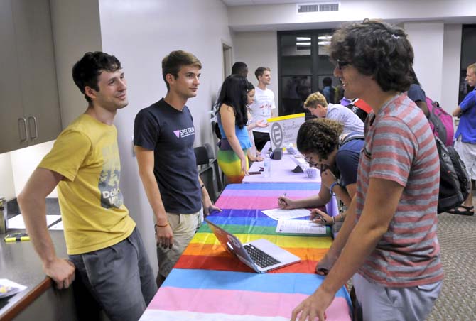 LSU physics senior Jacob Granger and anthropology sophomore Ray Siebenkittel discuss Spectrum club Thursday, Sept. 19, 2013 during Rainbow Rush