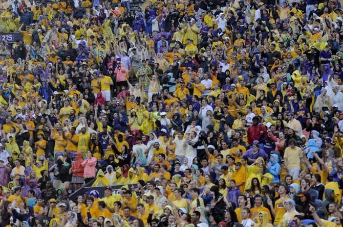 The LSU student section cheers on the Tigers in the rain Saturday, September 21, 2013, during the Tigers' 35-21 victory against Auburn in Tiger Stadium.