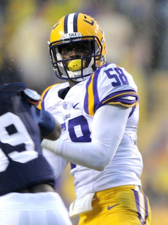 LSU senior linebacker Tahj Jones (58) attempts to dodge an Auburn player Saturday, Sept. 21, 2013 during the Tigers' 35-21 victory against Auburn in Tiger Stadium.