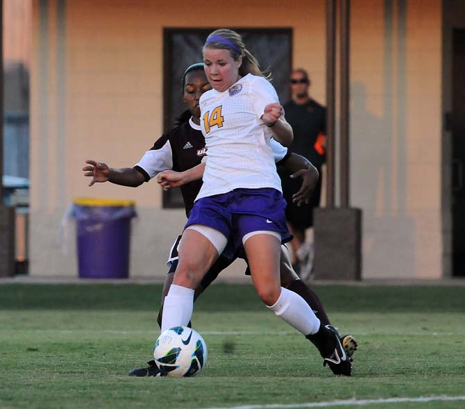 LSU Junior midfielder Alex Arlitt (14) drives the ball down the field August 27, 2013 at LSU Soccer Stadium.