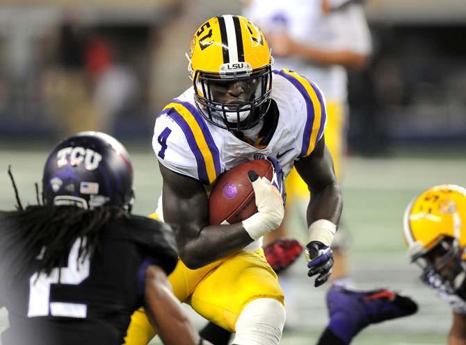 LSU senior running back Alfred Blue (4) attempts to maneuver around TCU senior corner back Jason Verrett (2) during the Tigers' 37-27 victory against the Horned Frogs Saturday, August 31, 2013 in the 2013 Cowboys Classic at AT&amp;T Stadium in Arlington, Texas.