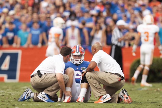 Florida quarterback Jeff Driskel (6) is looked after by trainers after being hit in the first quarter of an NCAA college football game against Tennessee at Ben Hill Griffin Stadium in Gainesville, Fla. on Saturday, Sept. 21, 2013. (AP Photo/The Tampa Bay Times, Will Vragovic)