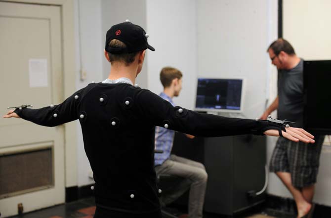 An LSU student participates in the digital animation process Sept. 9, 2013, while wearing a motion capture suit at the art building.