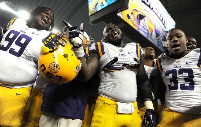 LSU freshman defensive tackle Greg Gilmore (99), junior defensive tackle Anthony Johnson (90) and sophomore running back Jeremy Hill (33) sing the LSU alma mater after the Tigers' 37-27 victory against TCU Saturday, August 31, 2013 in the 2013 Cowboys Classic at AT&amp;T Stadium in Arlington, Texas.