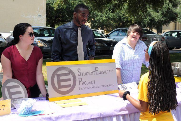 Student Equality Project president Armand Link and members Sydney Blanchard and Katie Perry tell LSU junior Ascha McDay about the new organization on Wednesday, Sept. 11, 2013 at the Student Involvement Fair.