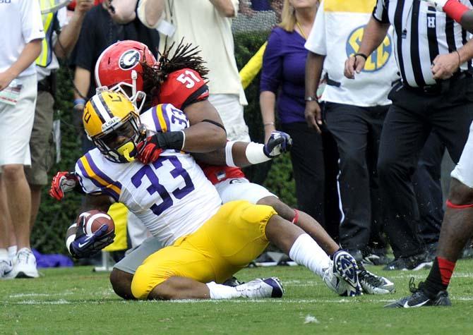 LSU sophomore running back Jeremy Hill (33) is tackled by UGA junior Ramik Wilson (51) on Saturday, Sept 28, 2013 during UGA's 44-41 victory against the Tigers in Sanford Stadium.