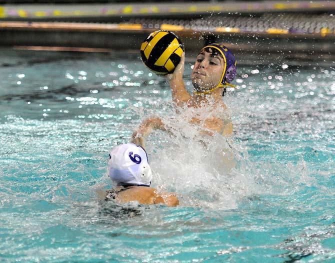 A member of the LSU Water Polo Club jumps out of the water before making a pass Monday, September 23, 2013 in the LSU Natatorium.