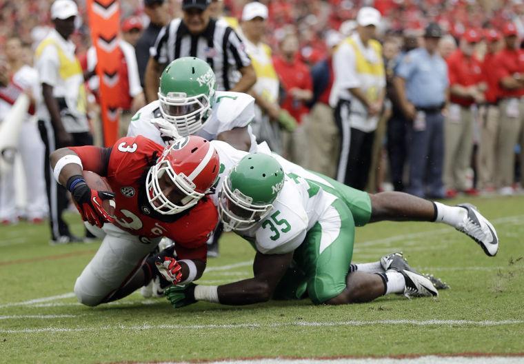 Georgia running back Todd Gurley (3) rushes for a touchdown as North Texas linebackers Zach Orr (35) and Derek Akunne (7) defend in the first half of an NCAA college football game Saturday, Sept. 21, 2013, in Athens, Ga. (AP Photo/John Bazemore)