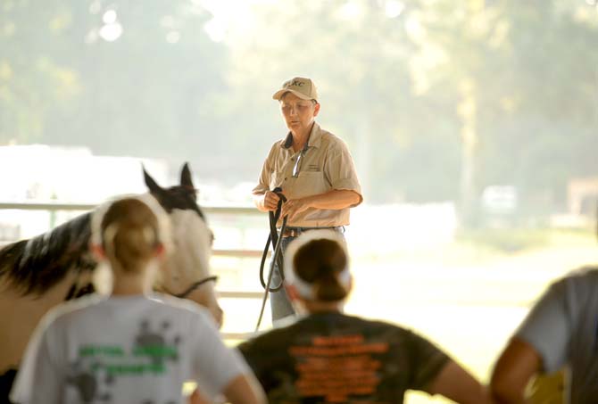 LSU Lab instructor, KC Annison, demonstrates the proper way to handle a horse Tuesday, Sept. 10, 2013 at BREC's Farr Park during the Horsemanship course offered to LSU students.