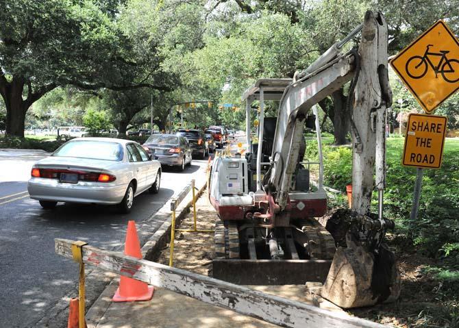 A piece of construction equipment sits motionless alongside Highland Road Monday, July 8, 2013 near the Student Union.