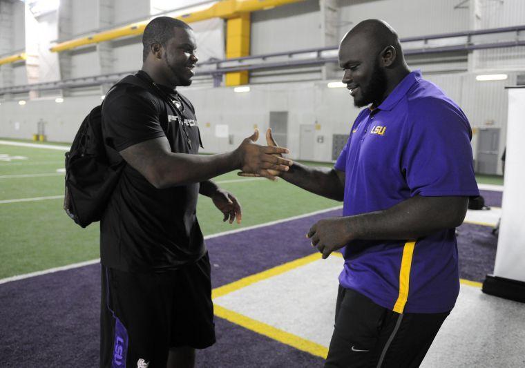 Anthony Johnson and Ego Ferguson shake hands Monday, Sept. 23, 2013 in the Charles McClendon Football Practice Facility.