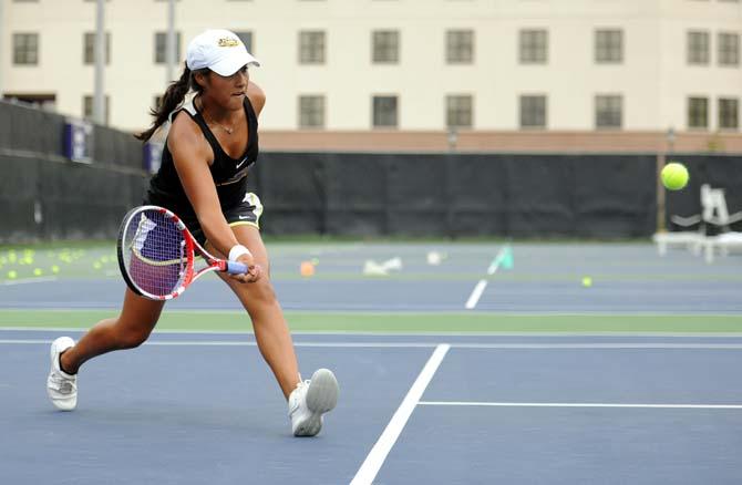 Gabrielle Otero, a new freshman on the women's tennis team, hits a ball at practice Tuesday, September 10, 2013.