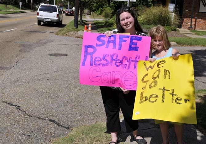 Katherine Eagerton, Denham resident, holds signs up with her daughter on September 2, 2013 during the Better Birth Rally in front of The Red Shoes on Government Street.