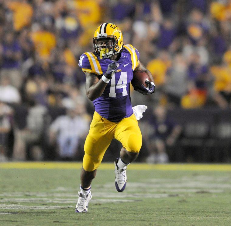 Running back Terrence Magee (14) runs the ball downfield Saturday night, Sept. 14, 2013 in the Tigers 45-13 victory against The Golden Flashes.