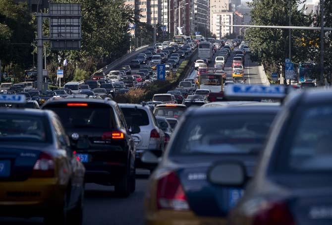 Streets covered in cars and traffic are prime places for hitchhikers to hitch a ride. (AP Photo/Andy Wong)