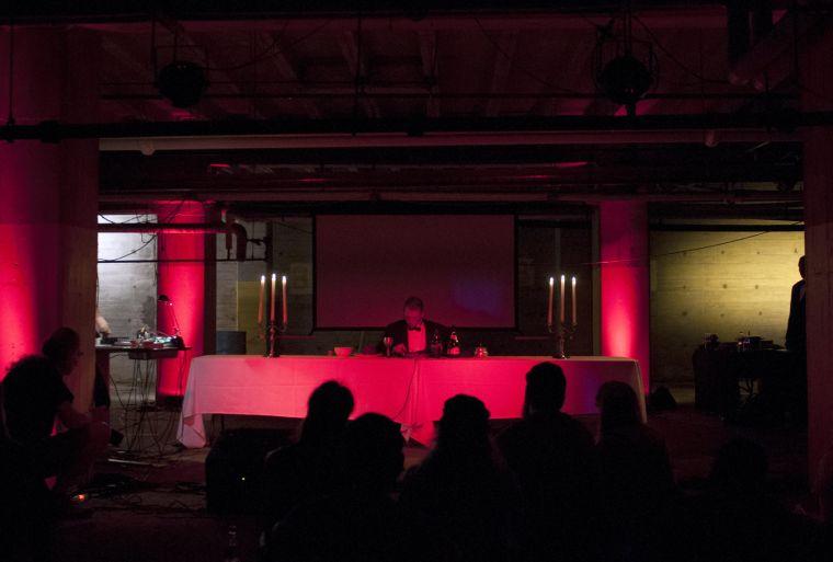 Peter Fetterman and Destiny Toro perform their piece "Dinner Party" on Friday night, Oct. 11 at MSPSNMF. As Fetterman consumes a four course meal, Toro controls microphones attached to bottles, plates, bowls and Fetterman's throat. The subtle noises echo throughout the empty parking garage and produce an absorbing piece of sound art.