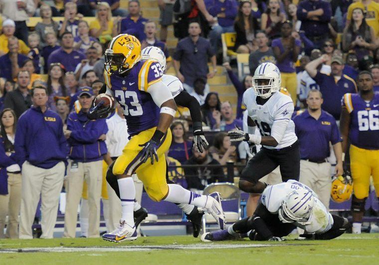 Sophomore running back Jeremy Hill (33) runs the ball downfield Saturday night, Oct. 26, 2013 during the Tigers' 48-16 win against Furman in Tiger Stadium.