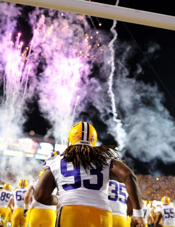 LSU junior defensive lineman Cleveland Davis (93) runs onto the field with his teammates Saturday Nov. 3, 2012 before the Tigers' 21-17 loss to Alabama in Tiger Stadium.