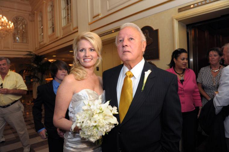 File-This July 29, 2011 file photo shows Trina Grimes Scott and former Louisiana Governor Edwin Edwards greet the media after getting married in the French Quarter in New Orleans, La. Edwards returns to the spotlight with the Sunday Oct. 27, 2013, premier of "The Governor's Wife," a new reality television series that puts his romance with Grimes out there for all to see. The couple &#8212; he's 86, she's 35 &#8212; has a child together. Eli was born in August. The series follows Trina and Edwin's decision to get pregnant and ends with the baby's delivery and introduction to the world. (AP Photo/Cheryl Gerber, File)