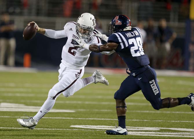 Texas A&amp;M quarterback Johnny Manziel (2) is tackled by Mississippi defensive back Mike Hilton (28) in the first half of an NCAA college football game at Vaught-Hemingway Stadium in Oxford, Miss., Saturday, Oct. 12, 2013. (AP Photo/Rogelio V. Solis)