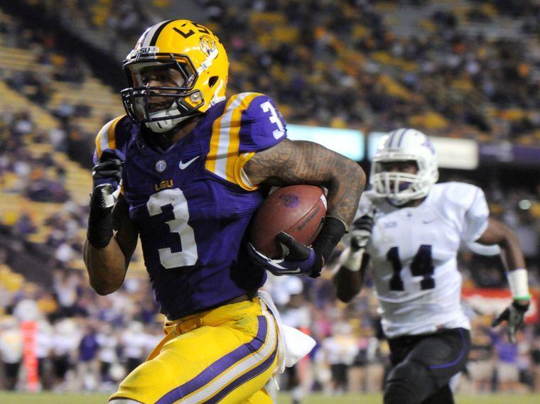 LSU junior wide receiver Odell Beckham Jr. (3) outruns Furman sophomore corner back Reggie Thomas (14) and scores a touchdown Saturday night, Oct. 26, 2013 during the Tigers' 48-16 win against Furman in Tiger Stadium.