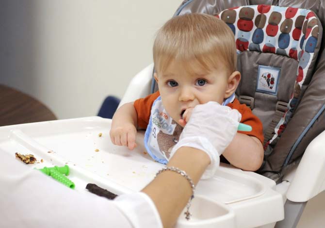 Grant Worthington learns how to properly eat and move his tongue Monday, October 7, 2013 in Hatcher Hall.