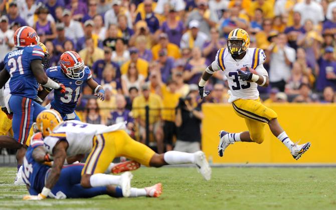 LSU sophomore running back Jeremy Hill rushes toward the first down Saturday, Oct. 12, 2013 during the Tigers' 17-6 victory against the Florida Gators in Tiger Stadium.