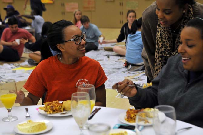 Accounting freshman Jordan Thomas enjoys being randomly selected as an Upper Class person at the 2013 Oxfam Hunger Banquet Wednesday, Oct. 23, 2013 in the Student Union.