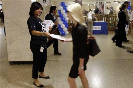 Wendy Jackson, left, and others with Independence Blue Cross mark the opening health insurance exchange by providing information on health car reform at Suburban Station Tuesday, Oct. 1, 2013, in Philadelphia. Tuesday is the first day of the open enrollment period for new health insurance options under the 2010 federal health care law. (AP Photo/Matt Rourke)