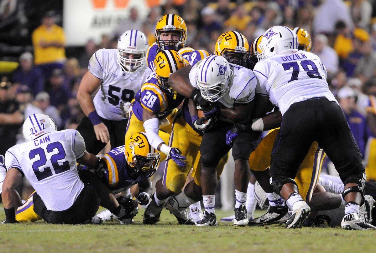 The LSU defense makes a stop Saturday night, Oct. 26, 2013 during the Tigers' 48-16 win against Furman in Tiger Stadium.