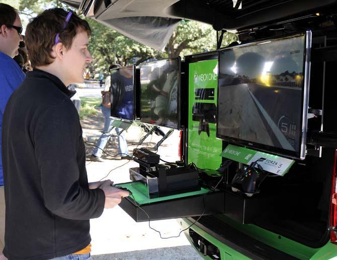 Mechanical engineering graduate student Shiloh Meyers plays "Forza Motorsport 5" on an Xbox One demo unit Friday, October 25, 2013, outside the Student Union.