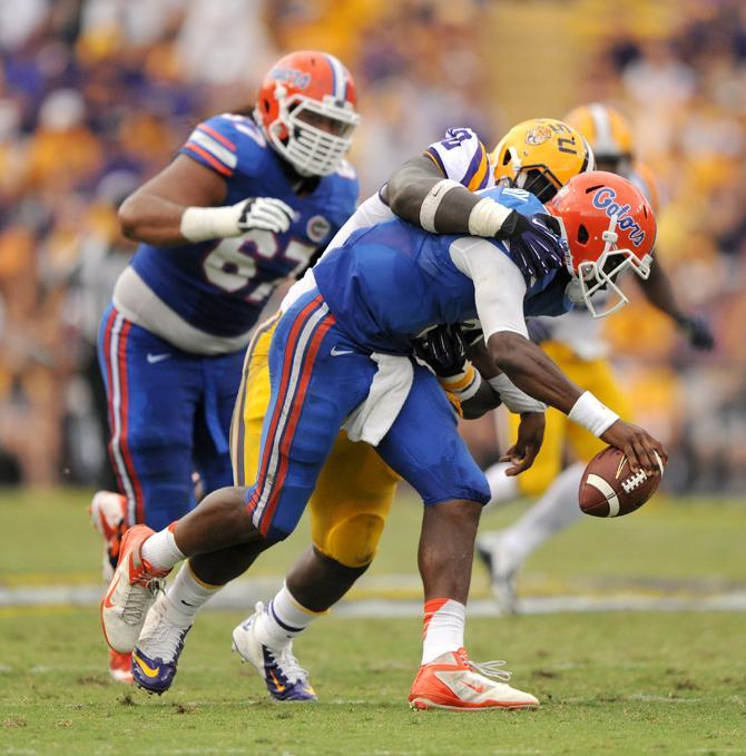 LSU junior defensive tackle Anthony Johnson (90) sacks Florida junior quarterback Tyler Murphy (3) during the Tigers' 17-6 victory against the Gators in Tiger Stadium.