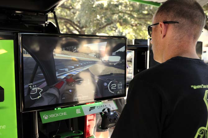 A student plays "Forza Motorsport 5" on an Xbox One on Friday outside the Student Union.