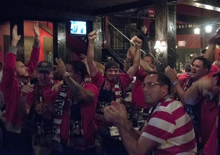 Craig Dupuy and other members of American Outlaws of Baton Rouge celebrate the USA soccer victory over Mexico on Tuesday, Sept. 10, 2013, at The Londoner Pub and Grill.