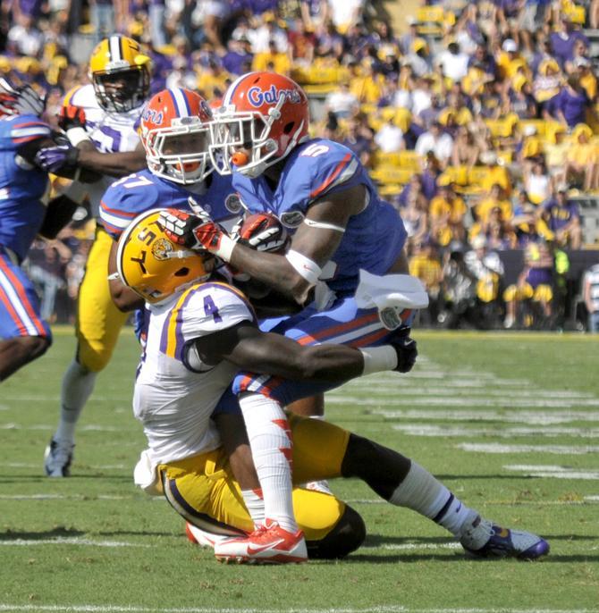 LSU senior running back Alfred Blue (4) tackles Florida junior defensive back Marcus Roberson (5) on Satuday, Oct. 12, 2013 during the Tigers' 17-6 victory against the Gators in Tiger Stadium.