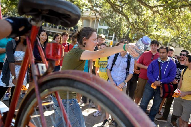 LSU Ag Center employee Lauren Hull, center, auctions off a bike Wednesday, Oct. 24, 2012, at the bike auction held near Free Speech Alley.